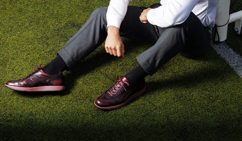 asics burgundy sneakers on model on grass