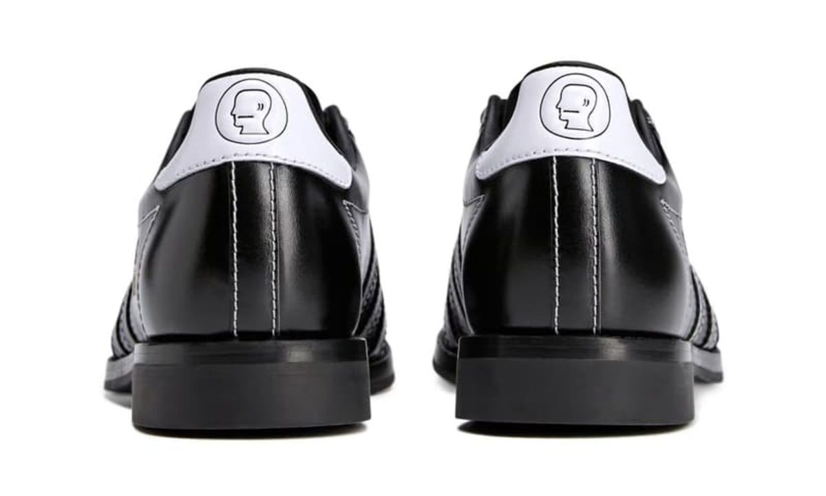 backside of white heel on black adidas bowling shoe