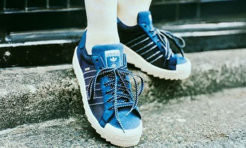 model weaing clot x adidas sneakers