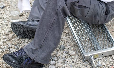man sitting on step wearing asics sneaker