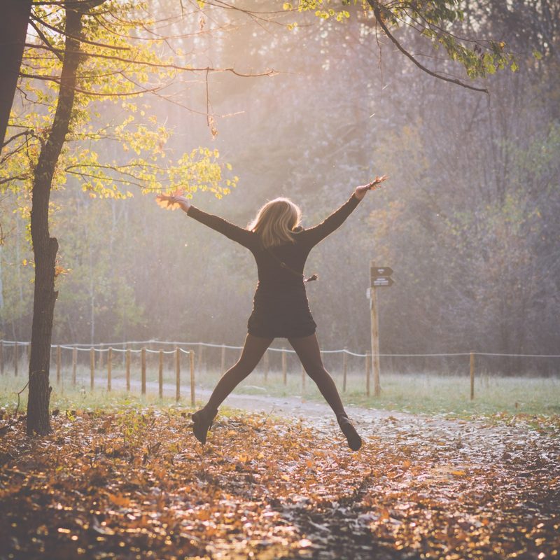Woman doing jumping jacks outside
