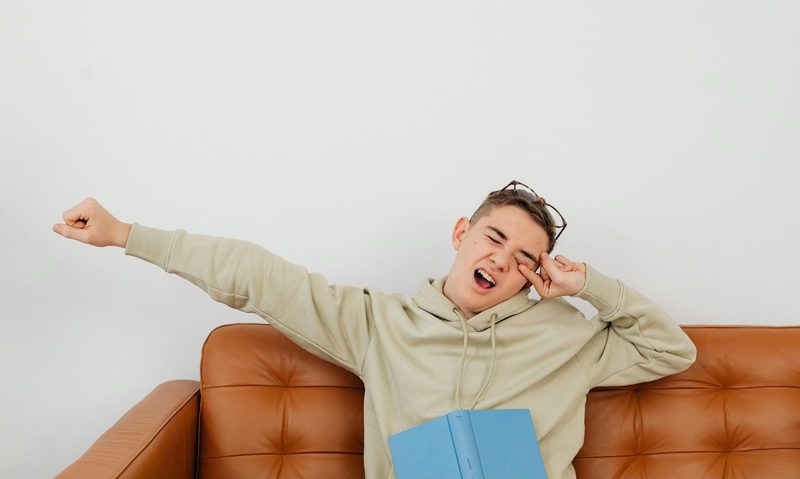 Man on couch yawning