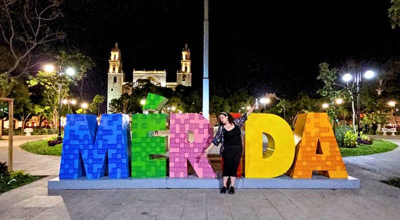 Merida letters in the town square with Rachel Dennis standing in front of the I