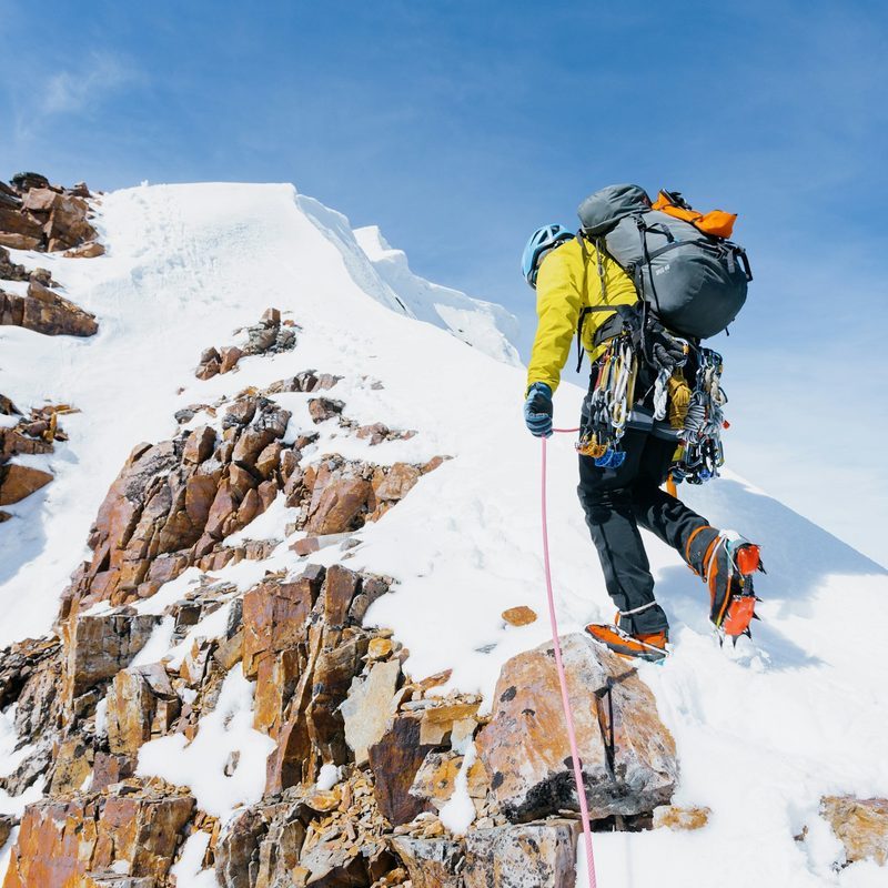 Man hiking a mountain with crampons