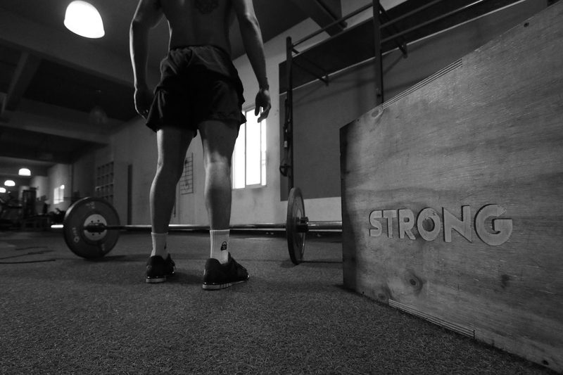 -man barbell on ground in gym strong