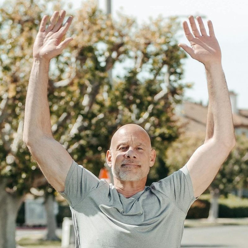 Man doing jumping jack outside