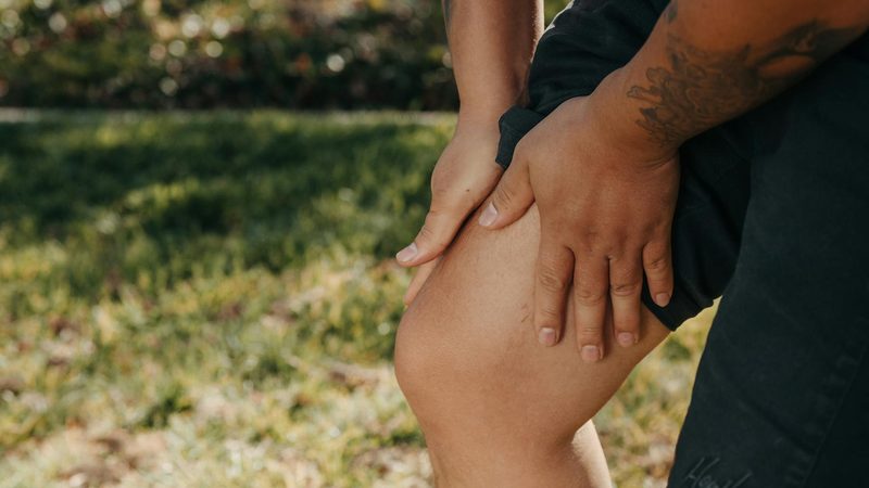 Man holding leg with cramp