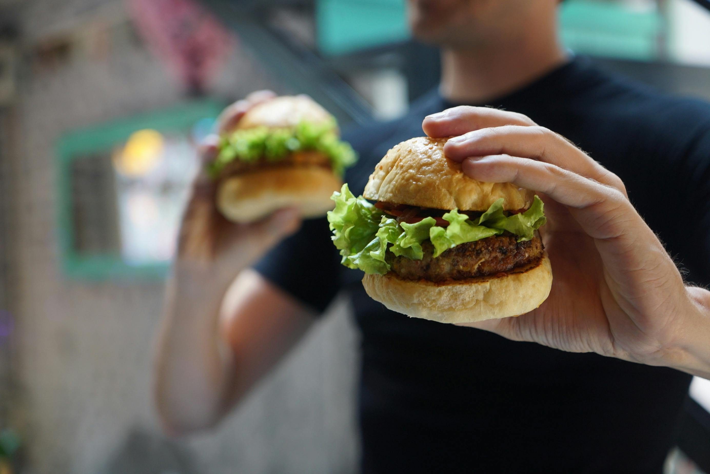 Man holding two burgers.