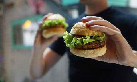 Man holding two burgers.