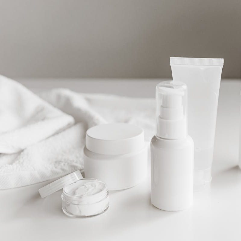 White skincare products on white counter