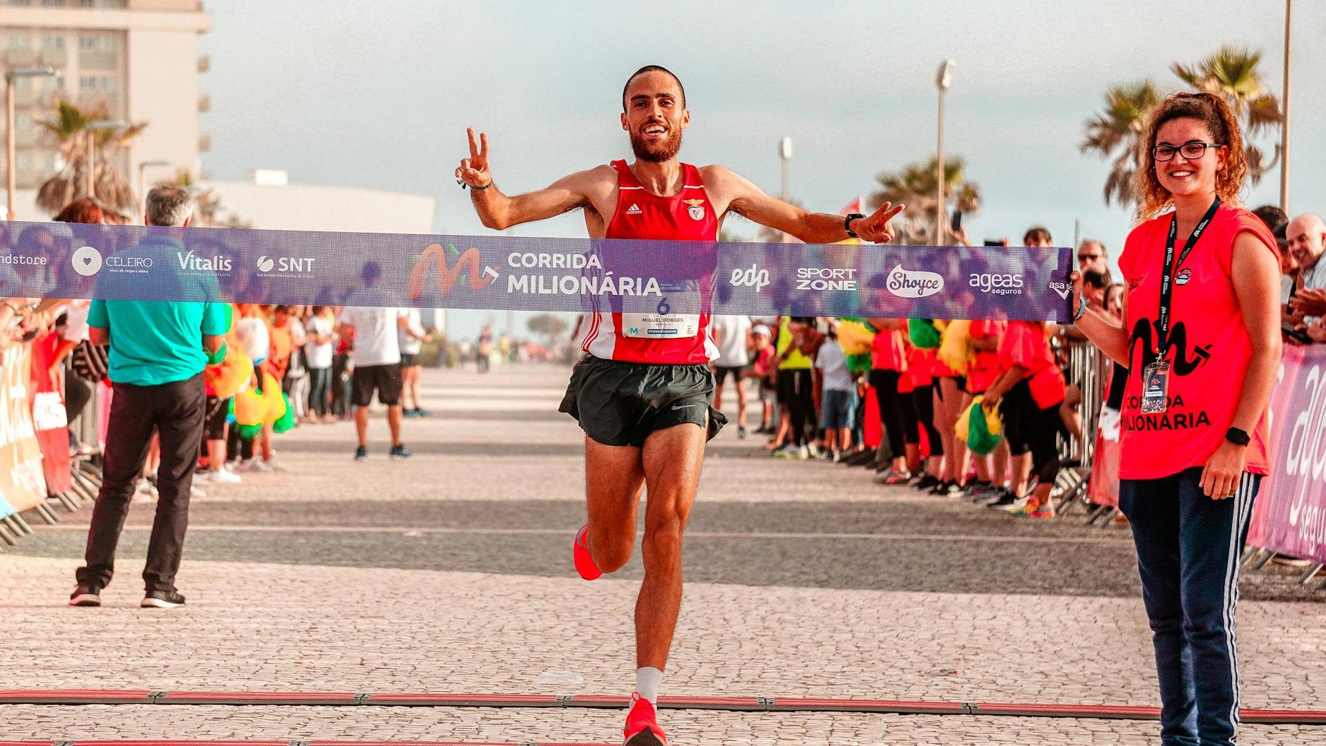 Happy man smiling crossing marathon finish line