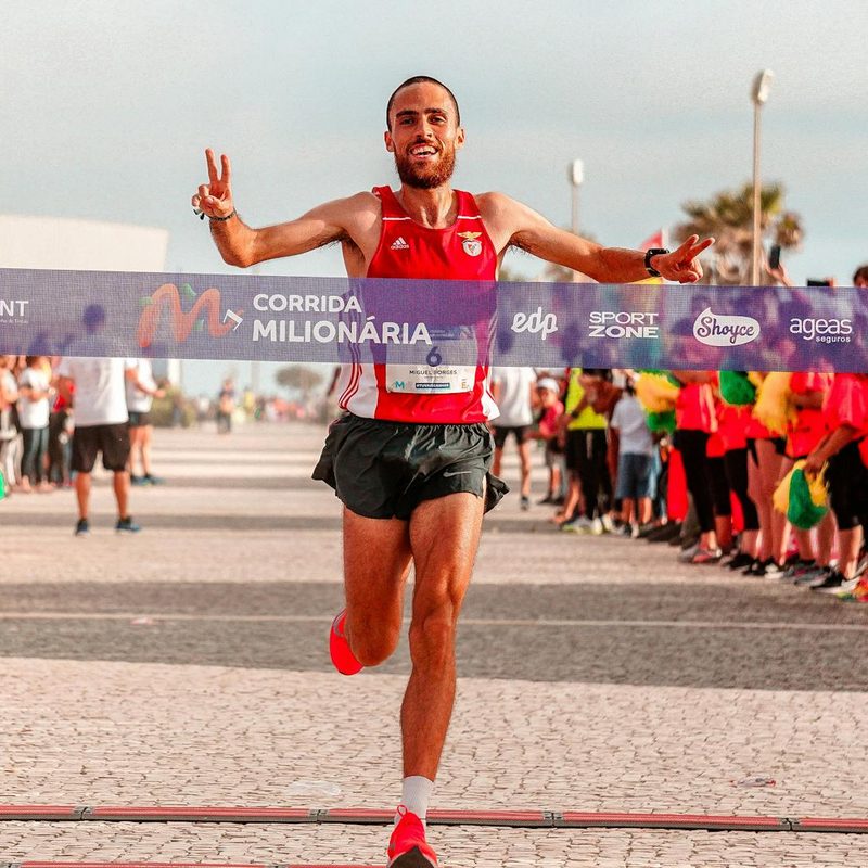 Happy man smiling crossing marathon finish line