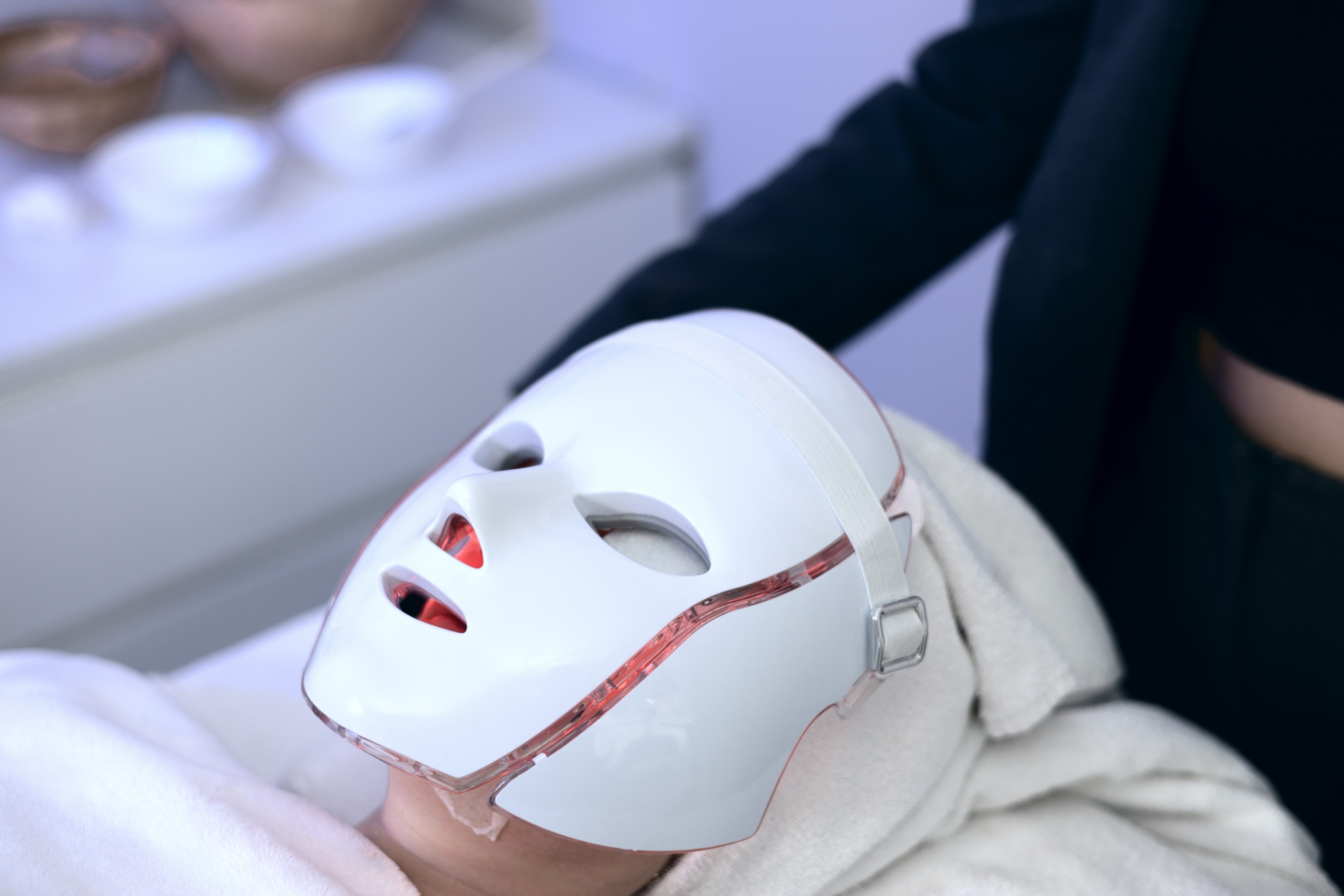 Woman with led light therapy facial and neck beauty mask photon therapy