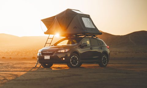 Roof Space 2 rooftop tent unfolded atop a small SUV in the desert.