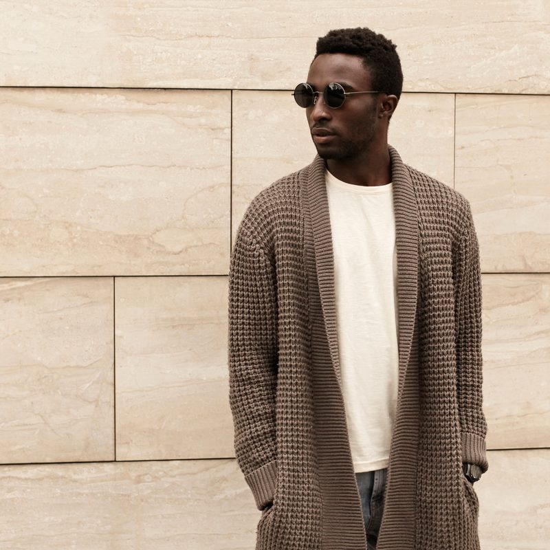 Model wearing oversized, brown knitted cardigan.