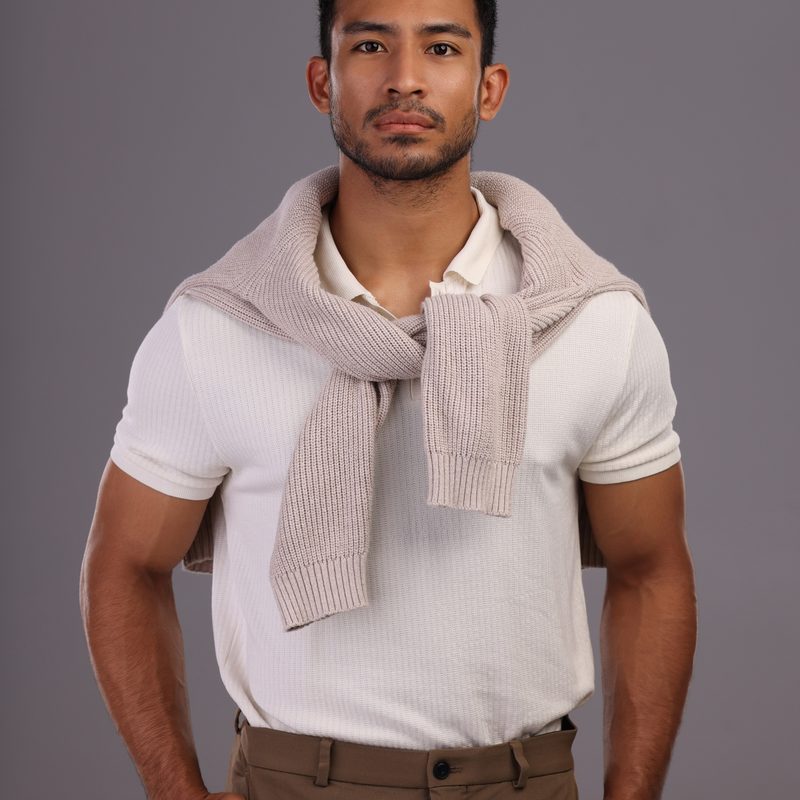 The cardigan loosely tied around the neck is a classic look.