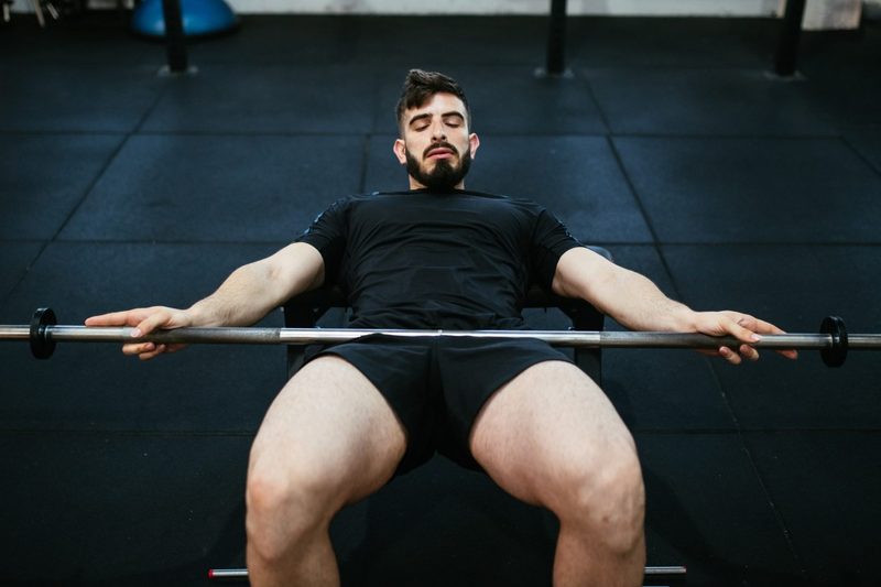 man doing hip thrust with barbell in gym - MIGUEL MARTINEZ FRIAS Shutterstock