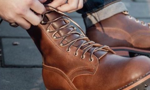 person tying laces on boots