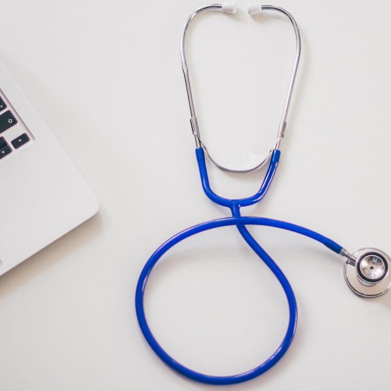 Stethoscope and laptop on table