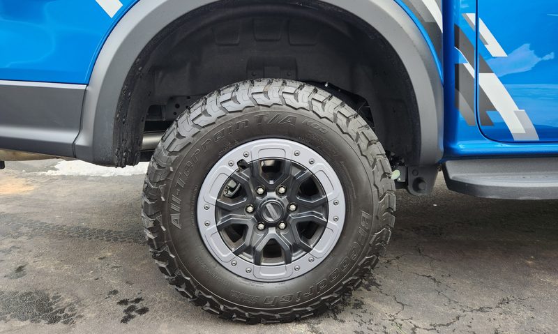 2024 Ford Ranger Raptor parked in a driveway BF Goodrich All-Terrain Mud and Snow tires.