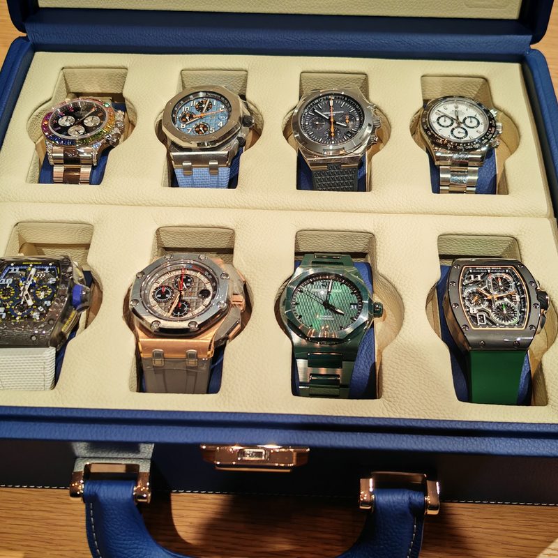 A case containing eight rare automotive-related watches