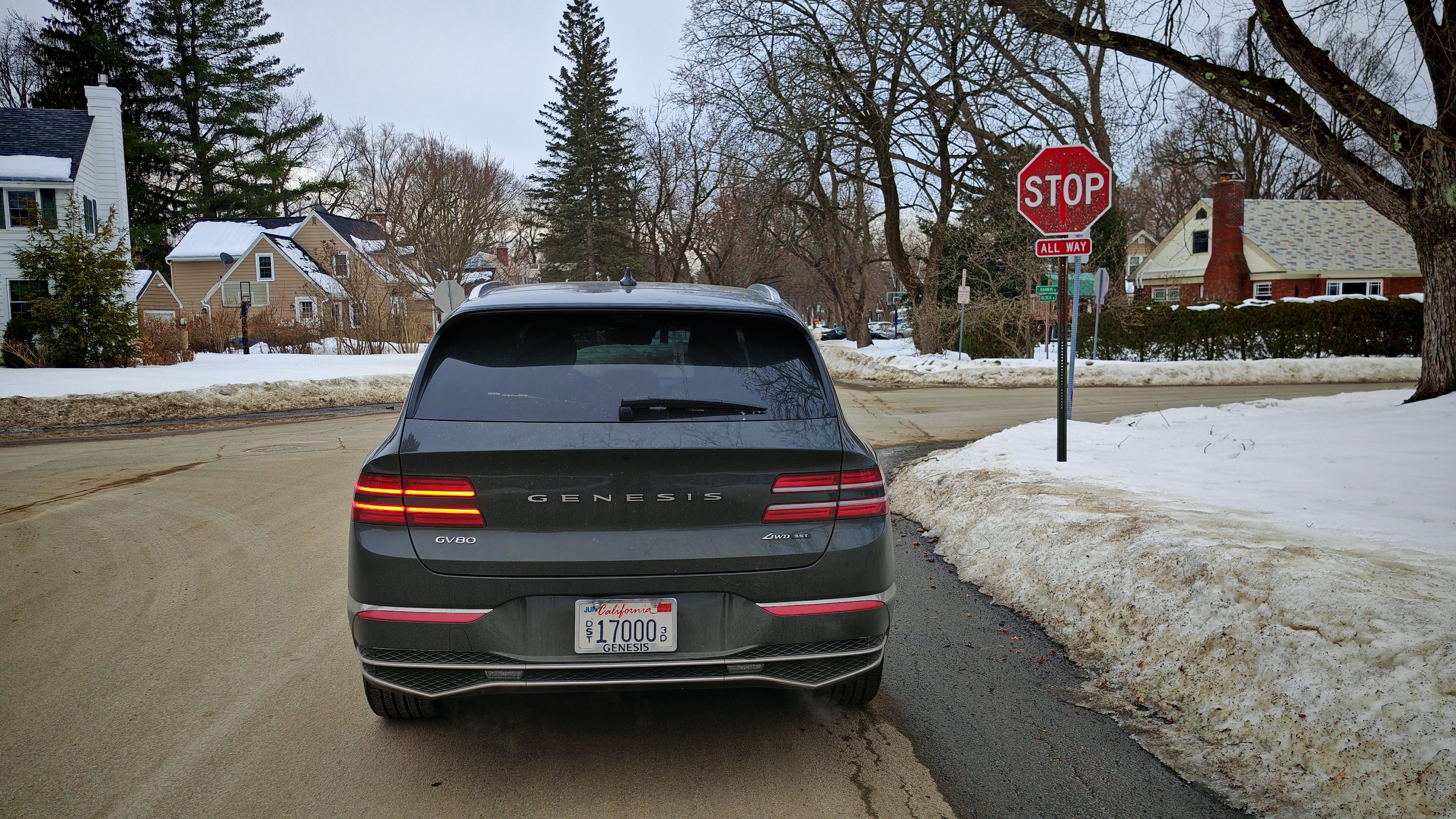 Rear view of the Genesis GV80 Prestigeindicating left at a stop sign