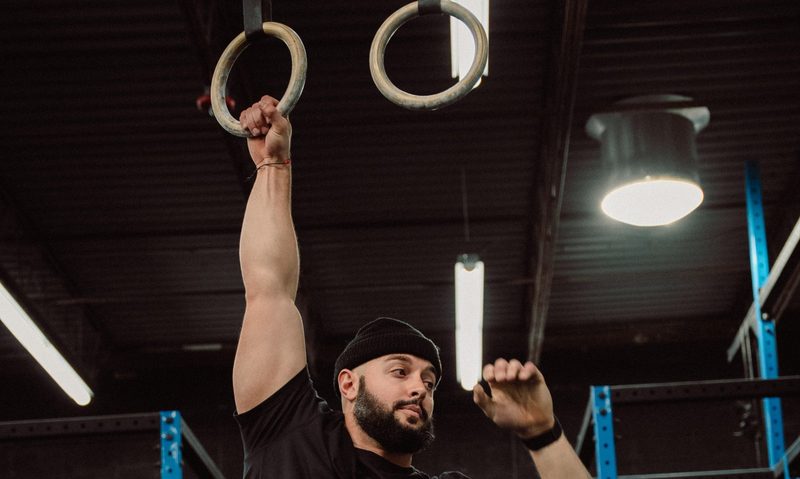 Mike Aidala hanging from bar stretching world record holder.
