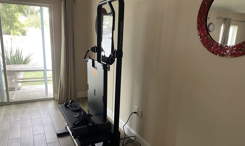 Speediance Gym Monster 2 folded up with bench and accessories on display