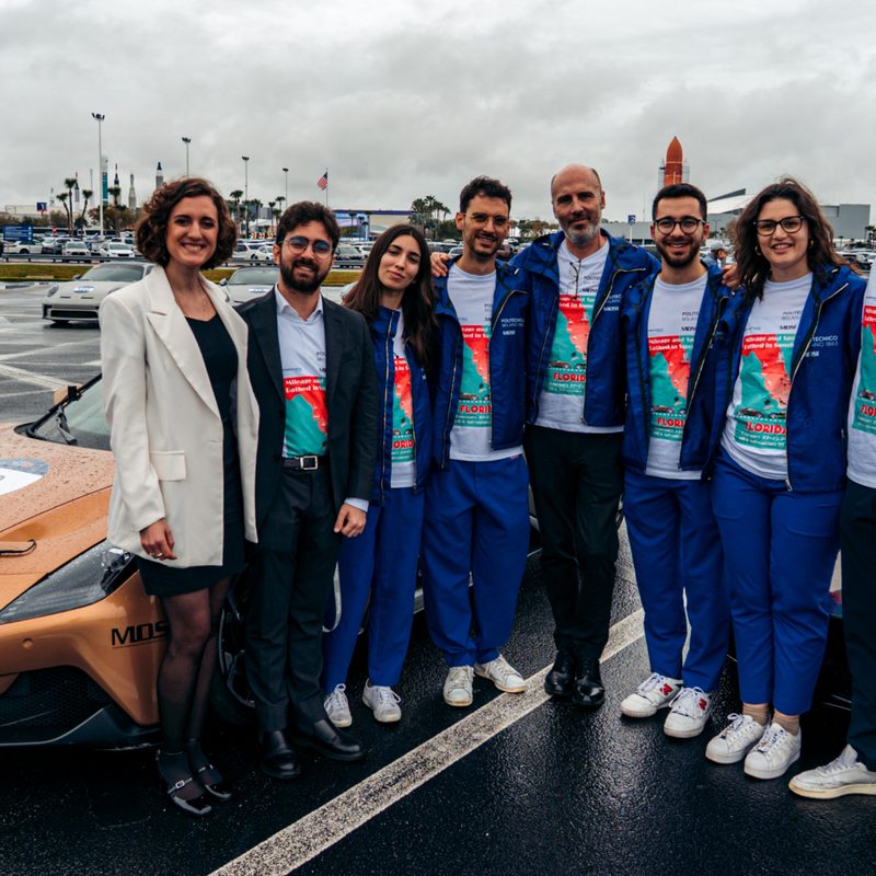 Team members with the two Maseratis involved with the World Autonomous Speed Record with the Indy Autonomous Challenge.
