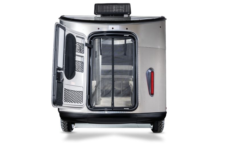 Rear view of a 2025 Airstream Basecamp 20Xe travel trailer isolated on a white studio background.