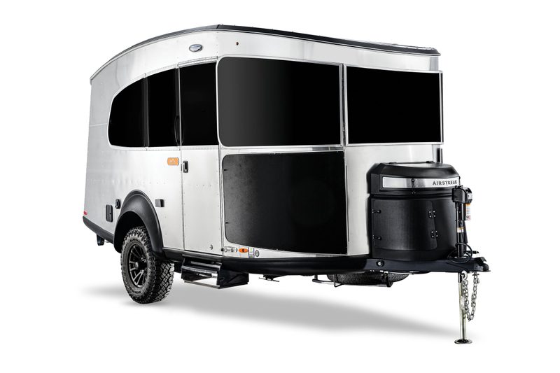 A 2025 Airstream Basecamp 20Xe travel trailer isolated on a plain white studio background.
