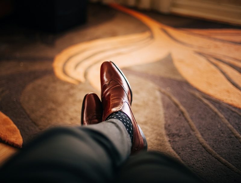 man wearing brown leather shoes