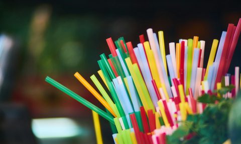 Plastic straws sitting in a jar