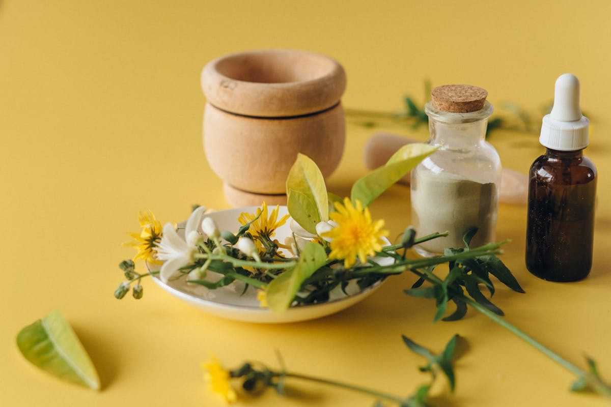 essential oil bottle and salt on yellow table