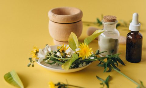 essential oil bottle and salt on yellow table