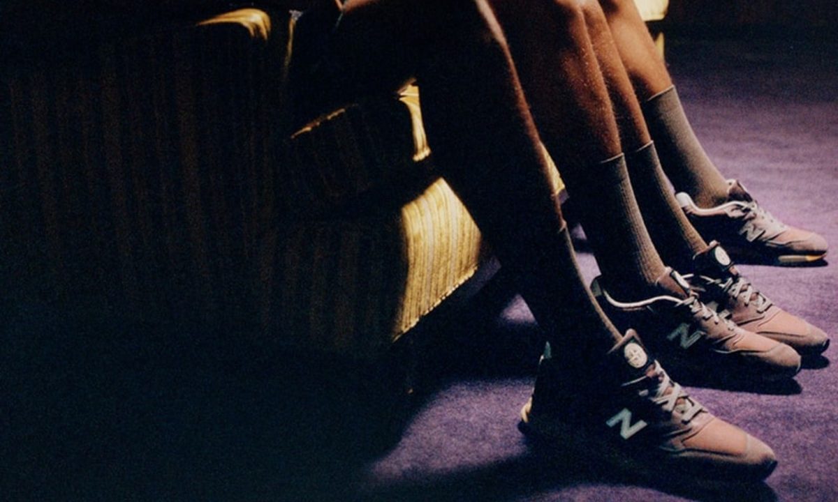 sitting on sofa with New Balance/Stone Island sneaker