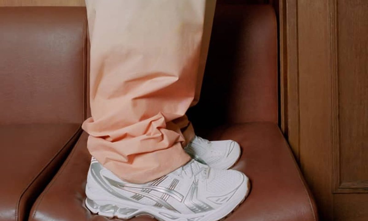 model wearing apc asics sneakers on chair