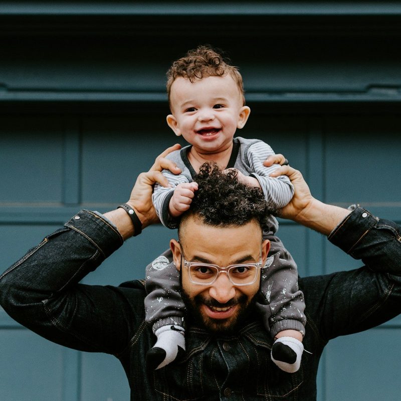 Happy dad with child on shoulders