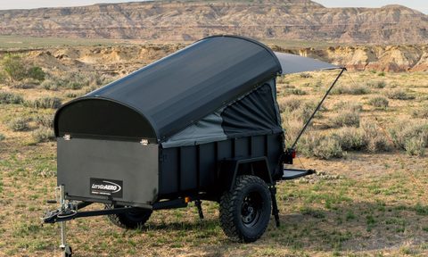 Let's Go Aero LittleGiant CrashPad camper trailer parked in a field.