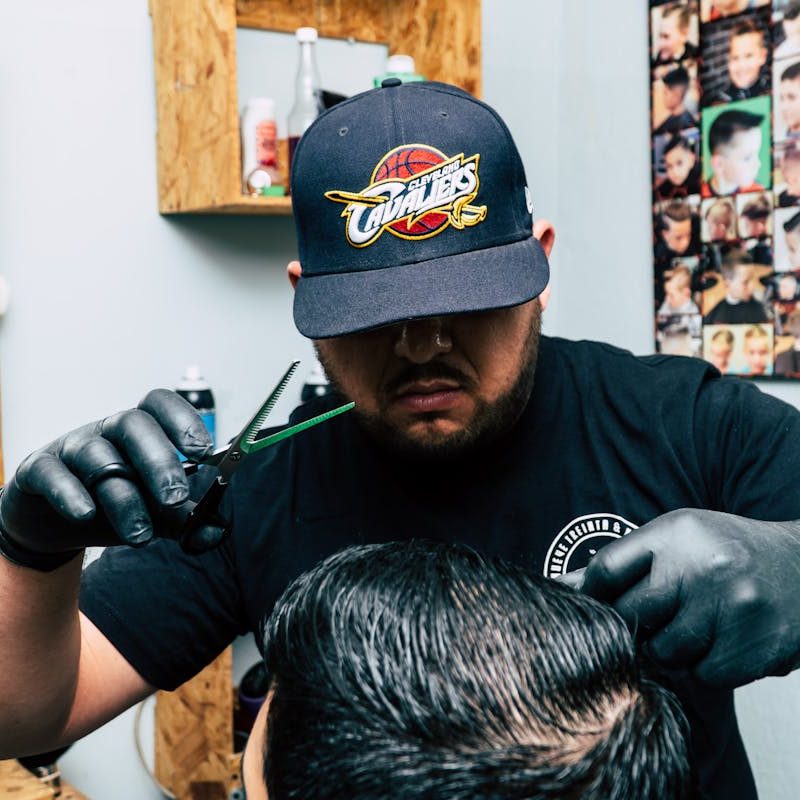A man getting hair cut at barber