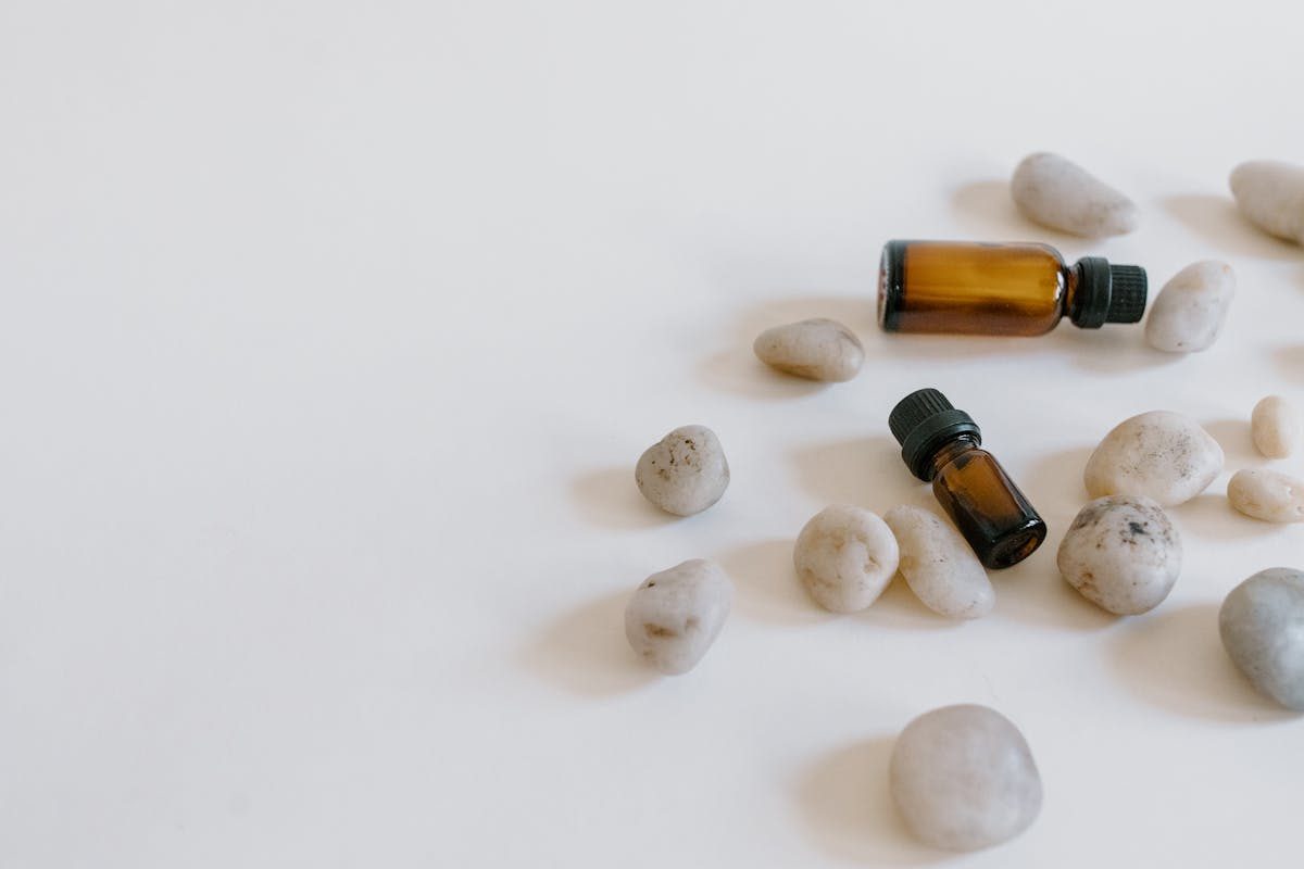 oils on white background with stones