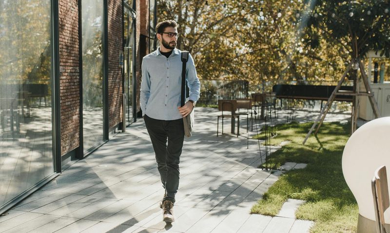 man walking outside wearing glasses