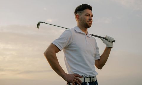 Man holding a golf club over his shoulder