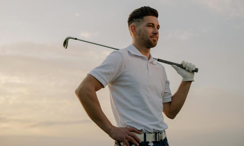 golf man holding golf club over shoulder
