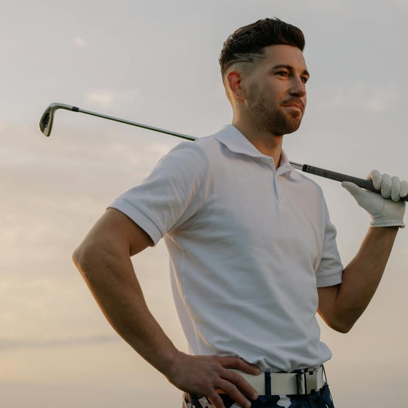 Man holding a golf club over his shoulder