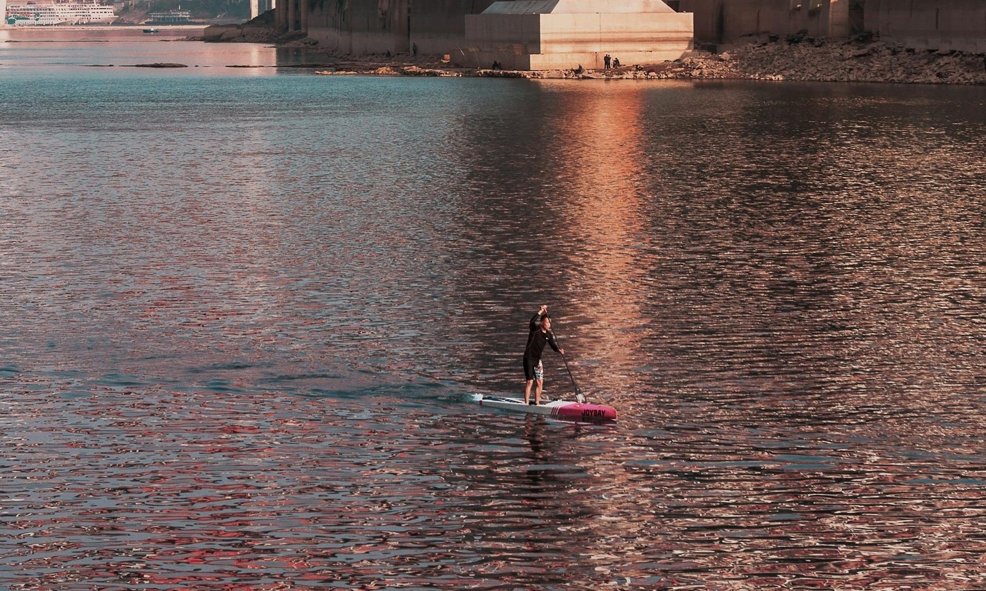 Man paddleboarding on water