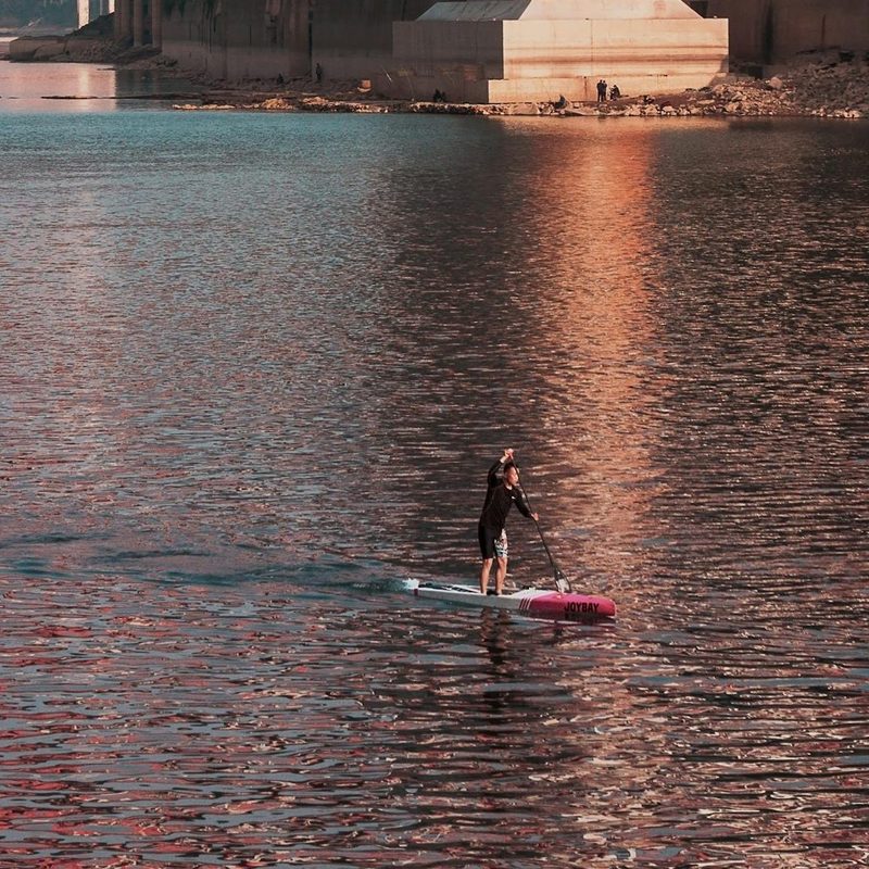 Man paddleboarding on water