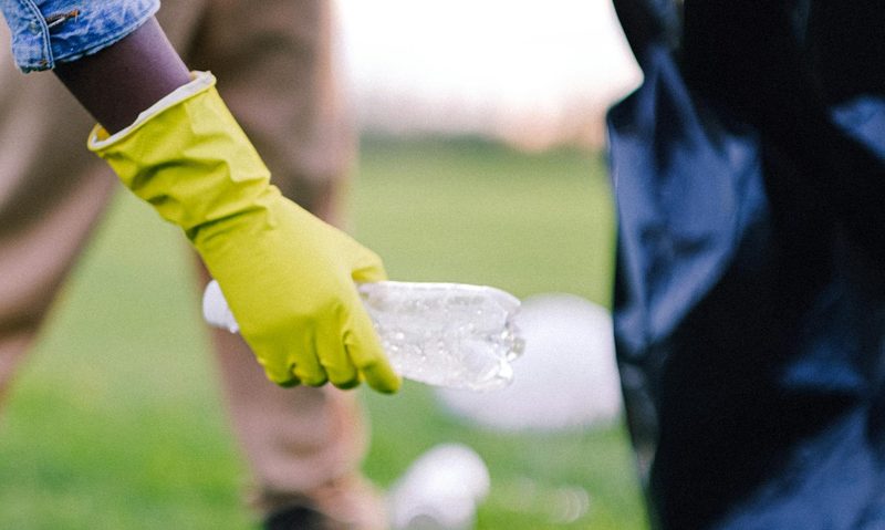 glove picking up trash