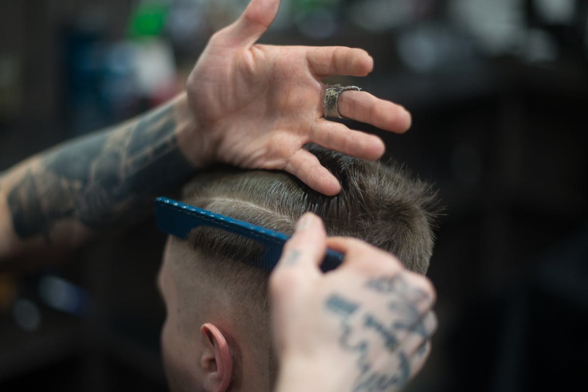 man getting haircut, view from back
