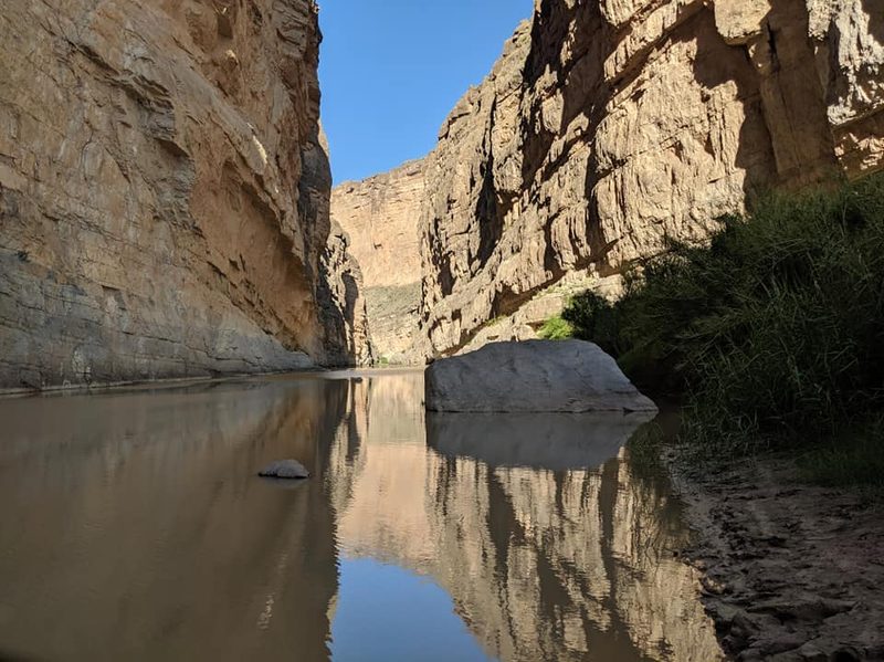 A view into Saint Elana Canyon with a still river in the foreground